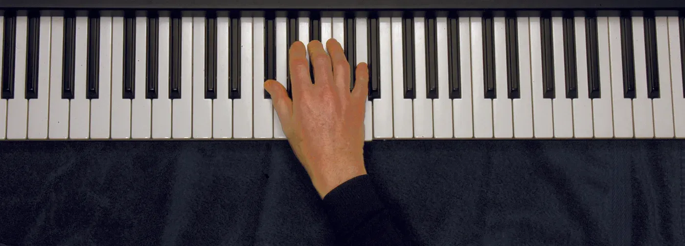 Aaug chord played on a piano — hand position on the keys