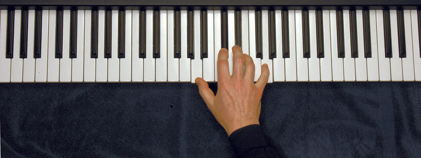 A7 chord played on a piano — hand position on the keys