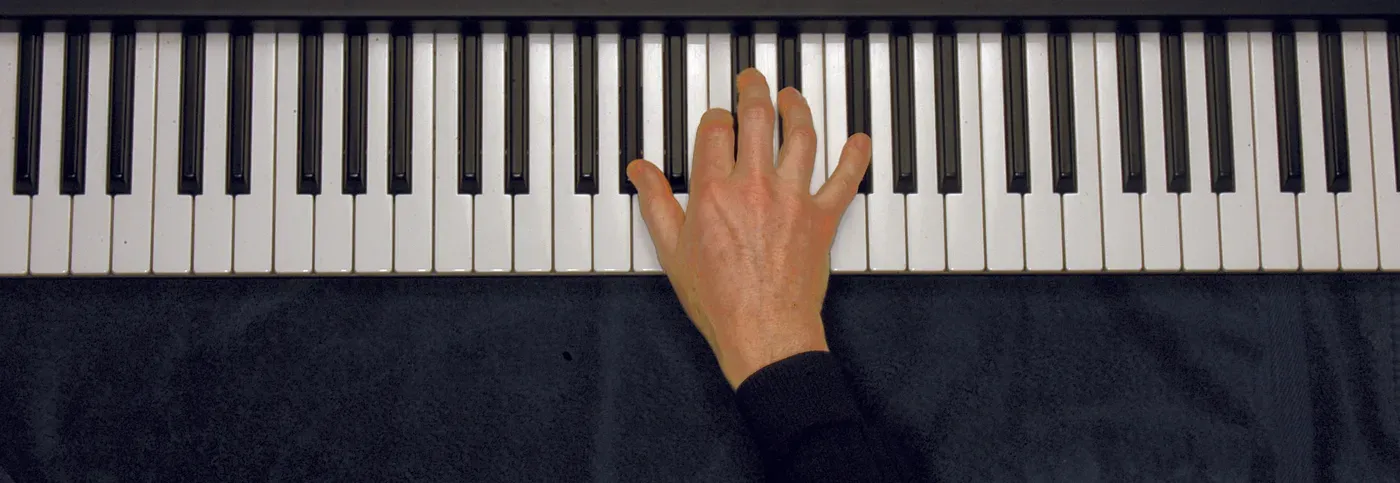 Ab7 chord played on a piano — hand position on the keys