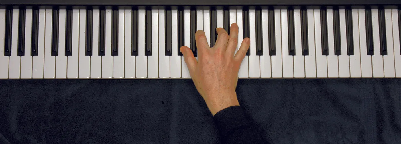 Abm7b5 chord played on a piano — hand position on the keys