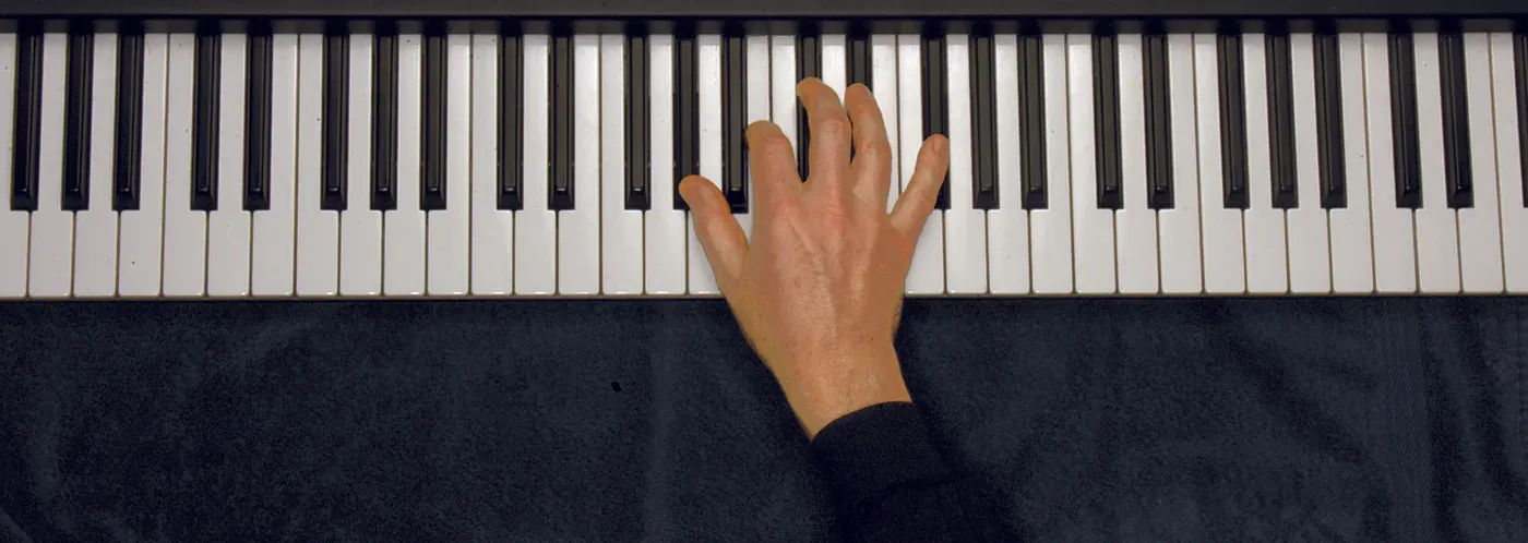Abm7 chord played on a piano — hand position on the keys