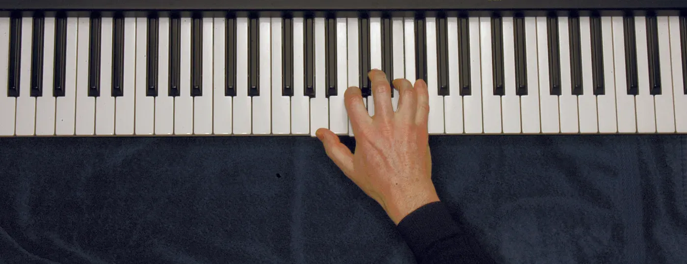Am6 chord played on a piano — hand position on the keys
