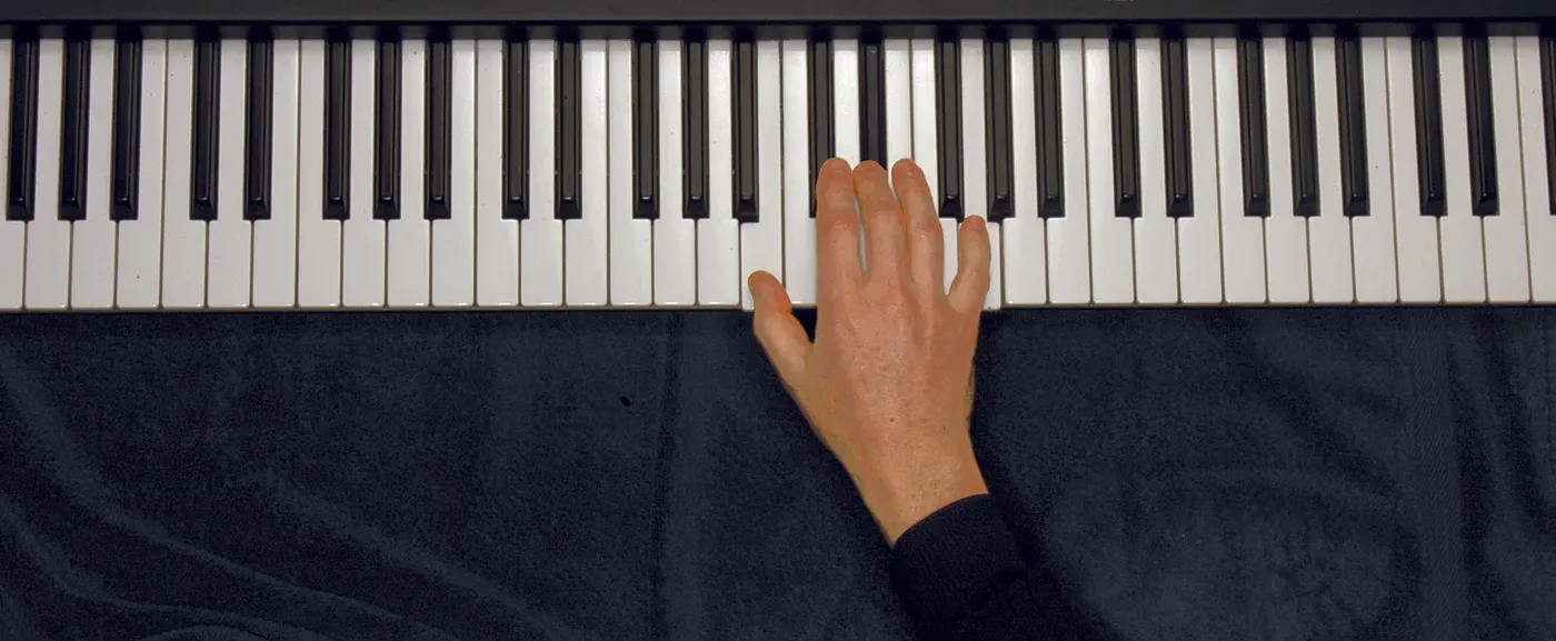 Baug chord played on a piano — hand position on the keys