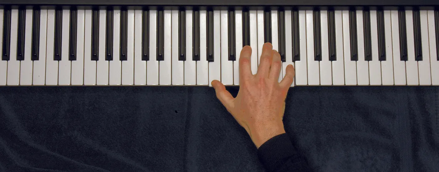 B7 chord played on a piano — hand position on the keys