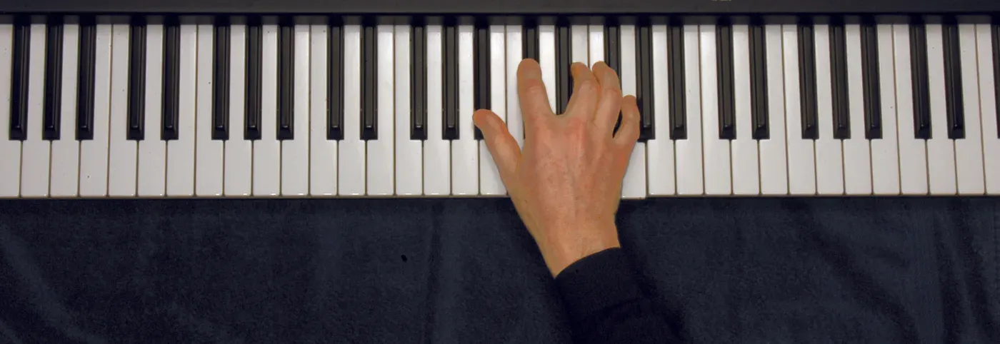 Bbdim7 chord played on a piano — hand position on the keys