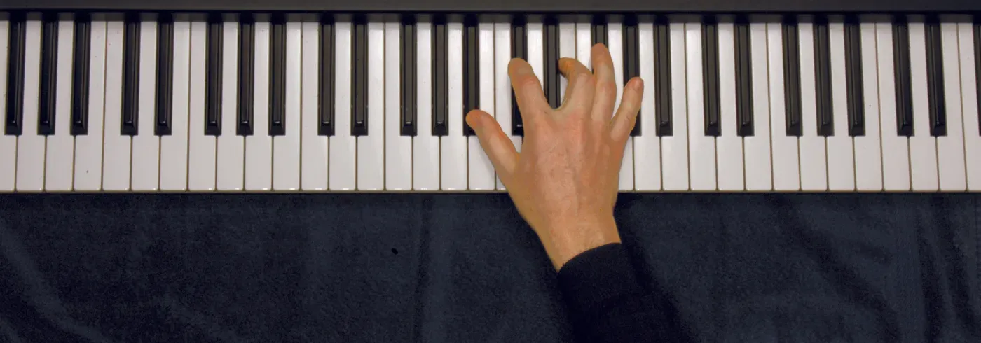 Bbm7b5 chord played on a piano — hand position on the keys