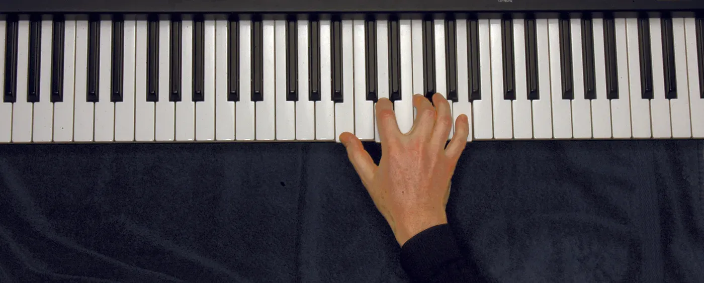 Bm7b5 chord played on a piano — hand position on the keys