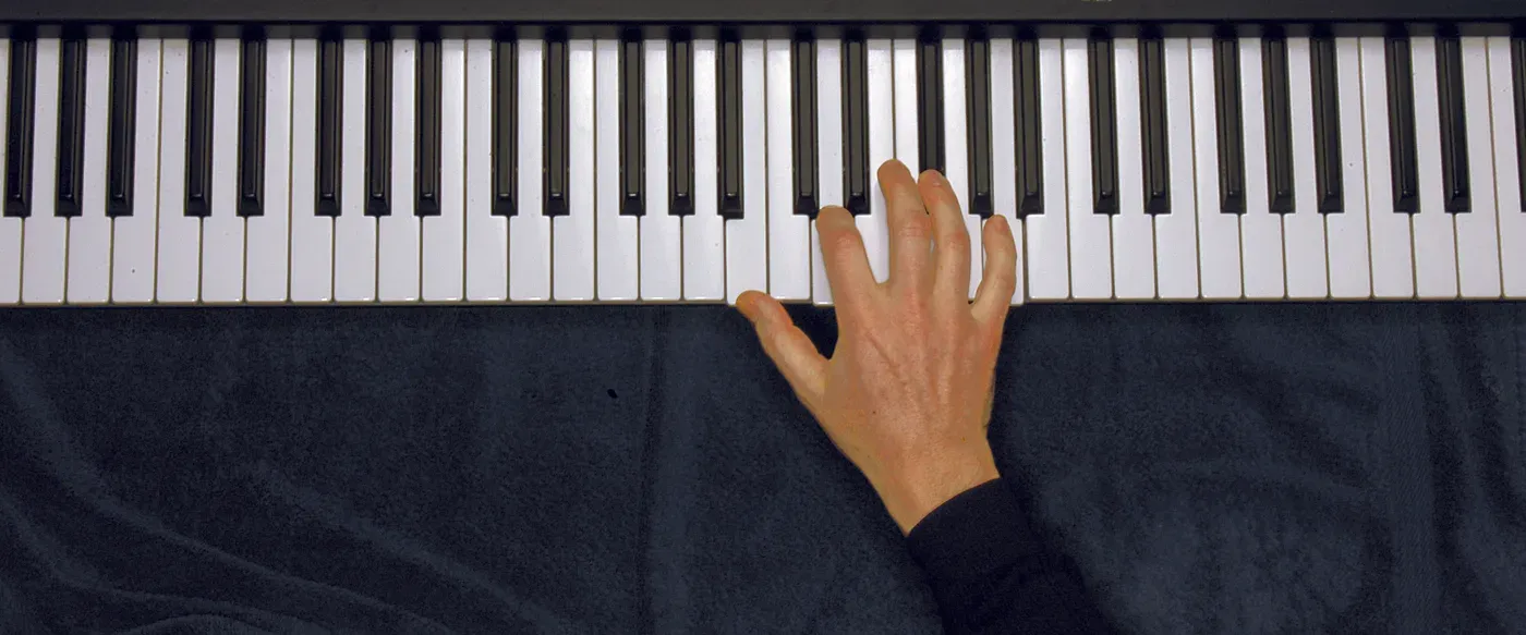 Bm7 chord played on a piano — hand position on the keys