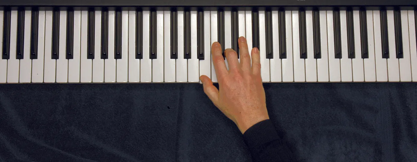 Bm chord played on a piano — hand position on the keys