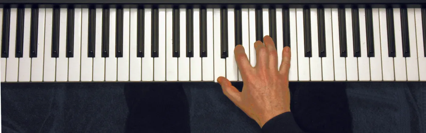 Cm7b5 chord played on a piano — hand position on the keys