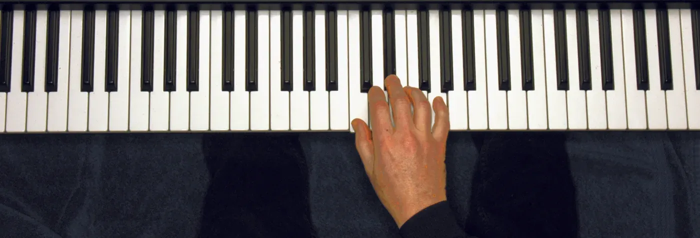 Cm chord played on a piano — hand position on the keys