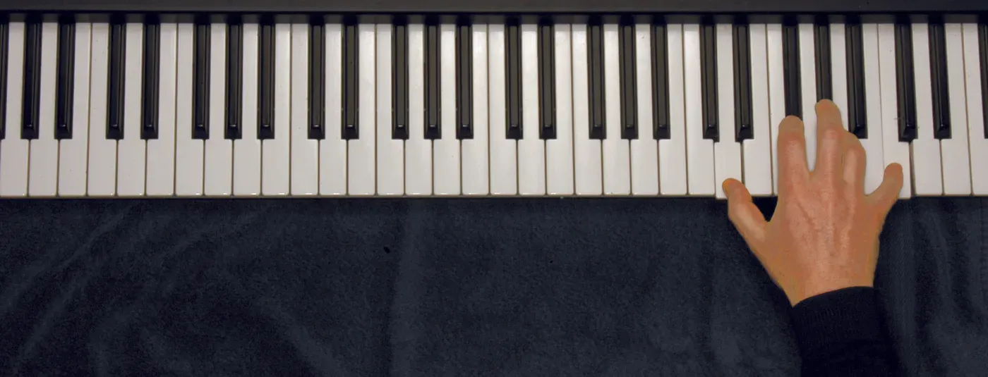 D7 chord played on a piano — hand position on the keys
