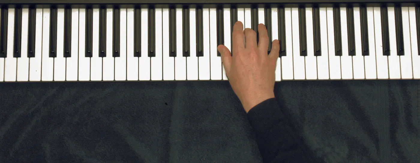 Dbaug chord played on a piano — hand position on the keys