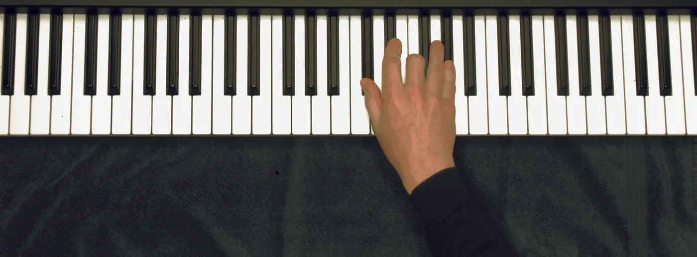 Db chord played on a piano — hand position on the keys