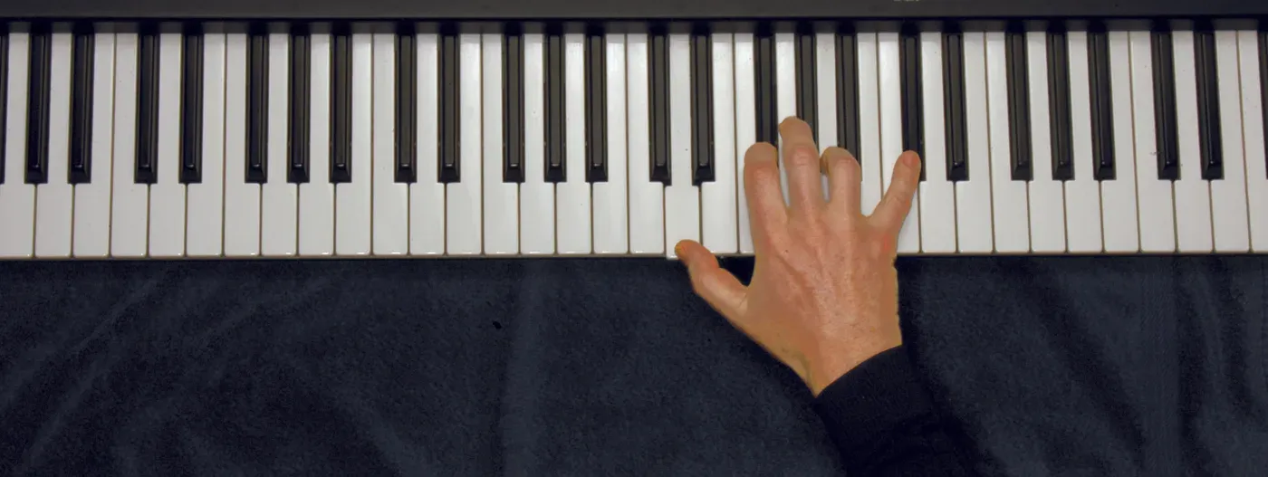 Dmaj7 chord played on a piano — hand position on the keys