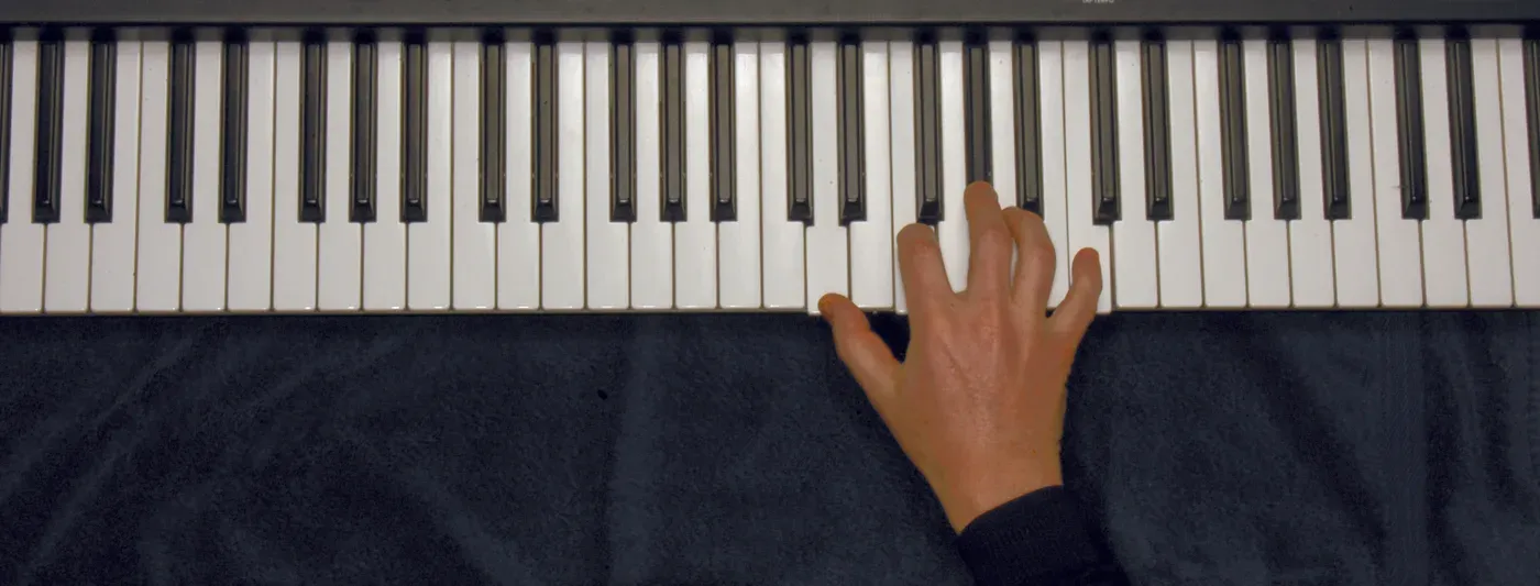 Dm7b5 chord played on a piano — hand position on the keys