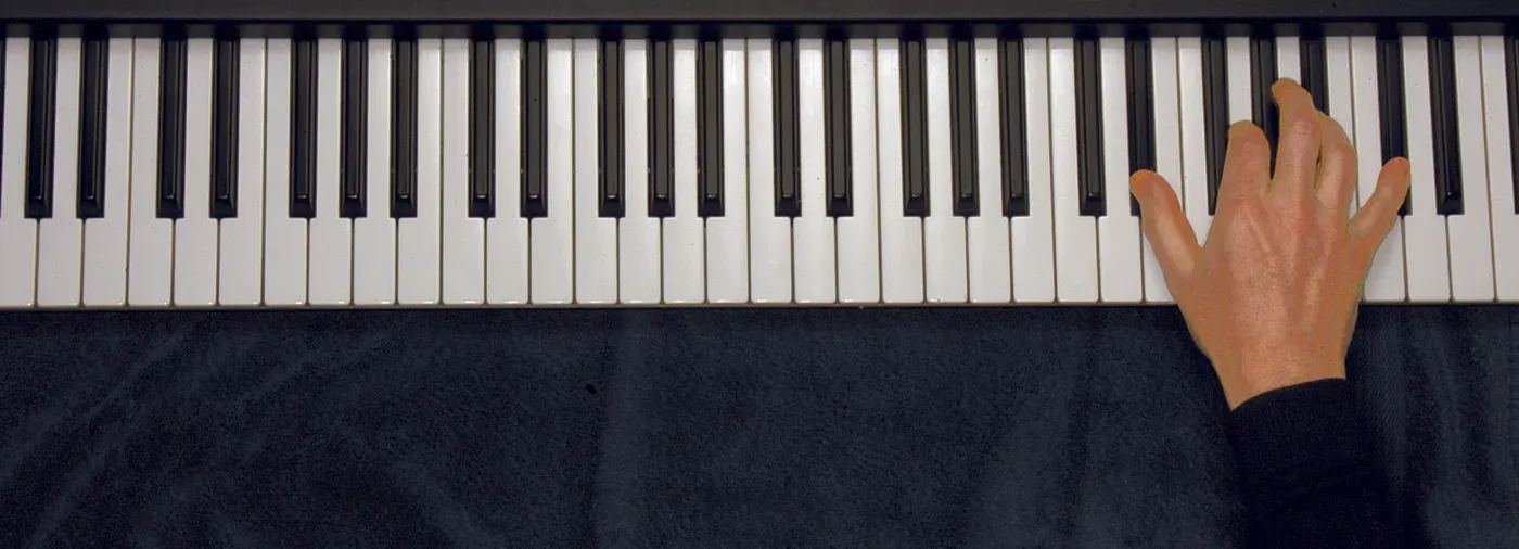 Eb7 chord played on a piano — hand position on the keys