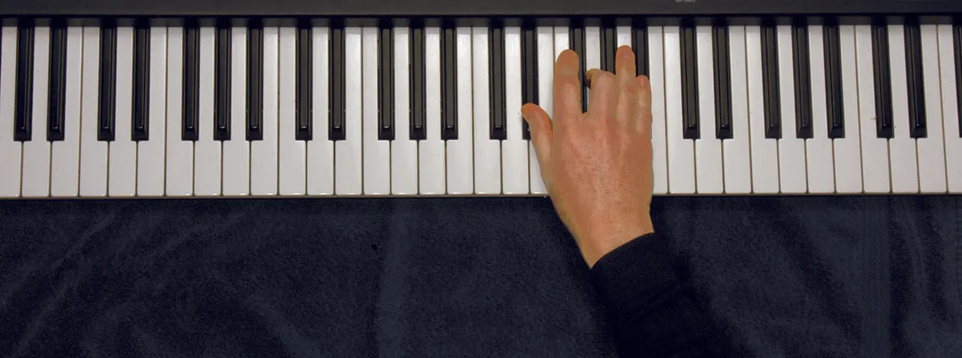 Eb chord played on a piano — hand position on the keys