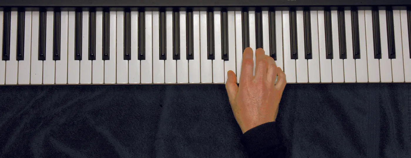 E chord played on a piano — hand position on the keys
