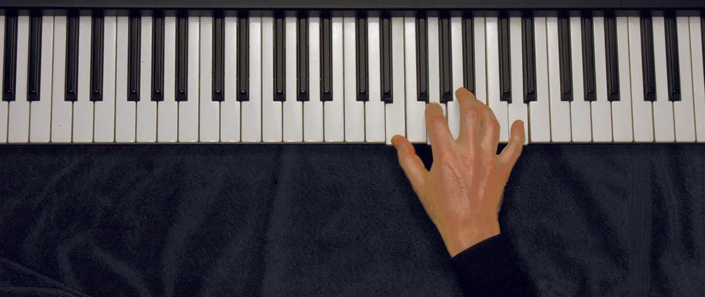 Em7 chord played on a piano — hand position on the keys