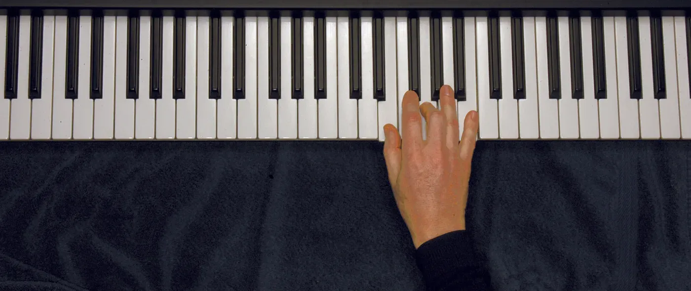 Em chord played on a piano — hand position on the keys