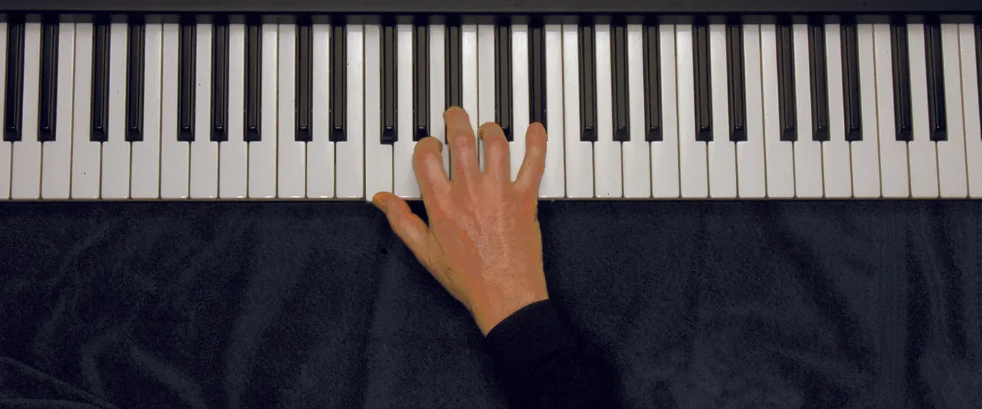 F7 chord played on a piano — hand position on the keys