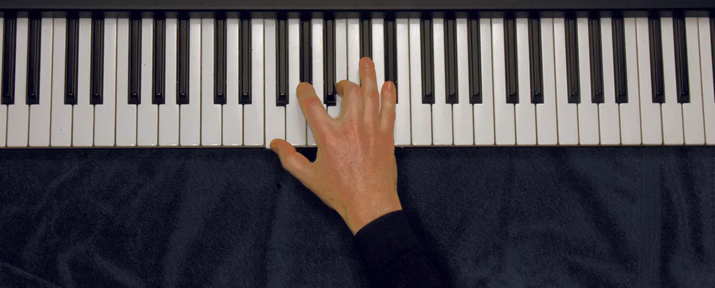 Fm7b5 chord played on a piano — hand position on the keys