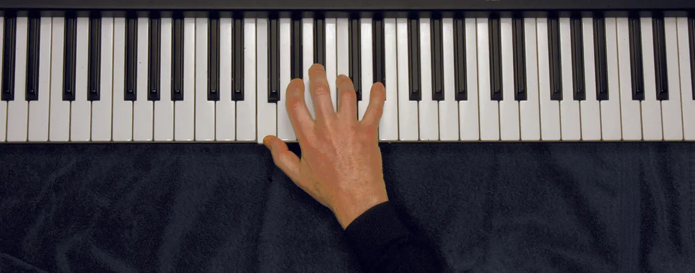 Fm7 chord played on a piano — hand position on the keys