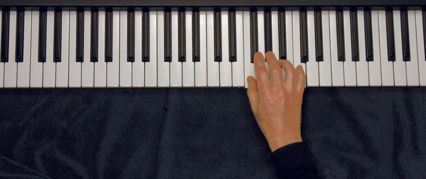 Fm chord played on a piano — hand position on the keys