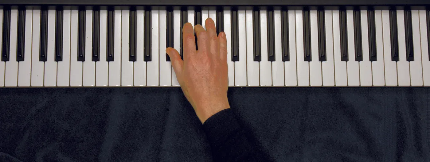 Gb chord played on a piano — hand position on the keys