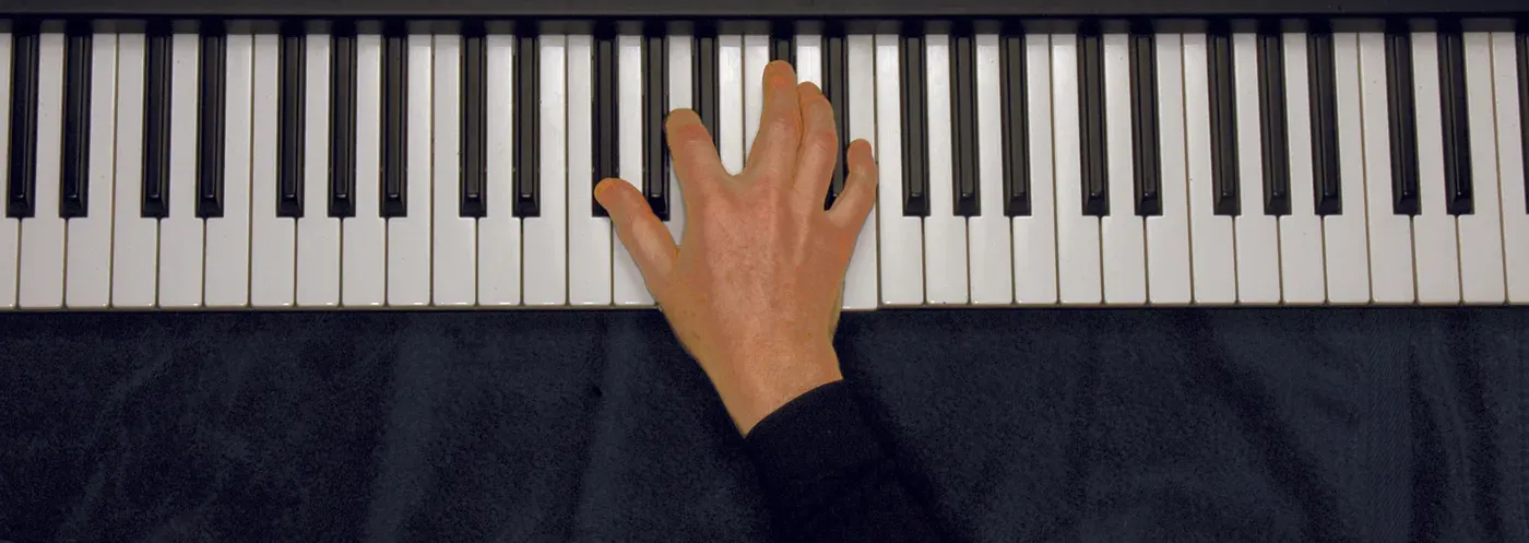 Gbm7 chord played on a piano — hand position on the keys