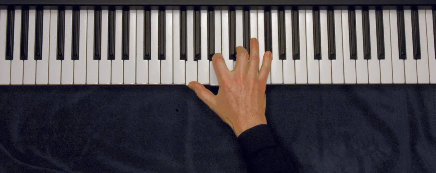 Gmaj7 chord played on a piano — hand position on the keys